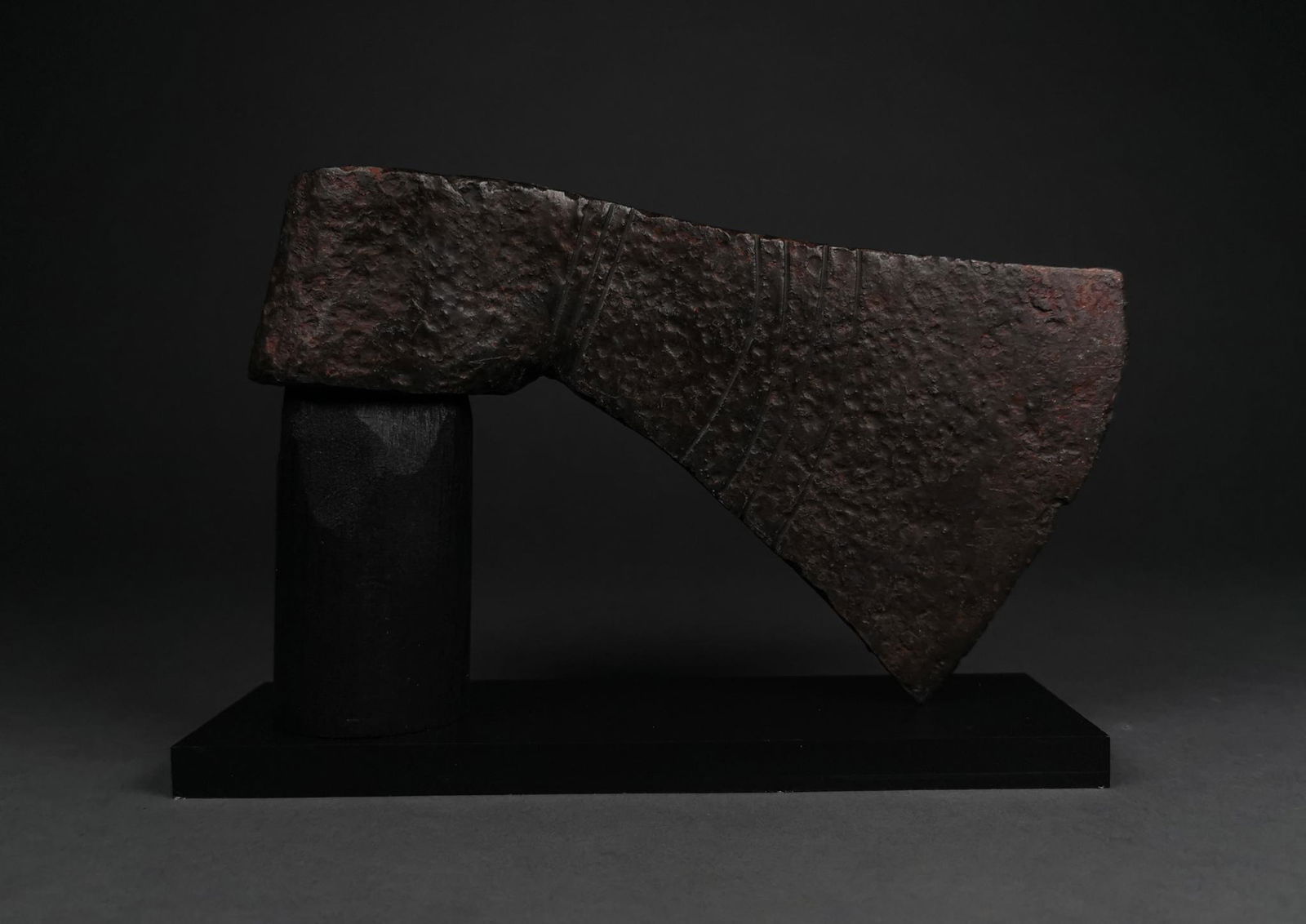 VIKING IRON AXE WITH DECORATION ON STAND: c. 900-1100 AD. Viking age. This iron battle axe features a circular socket and a long head, flaring towards thee blade. Etched decoration is present on both faces of the blade; on one side this compr