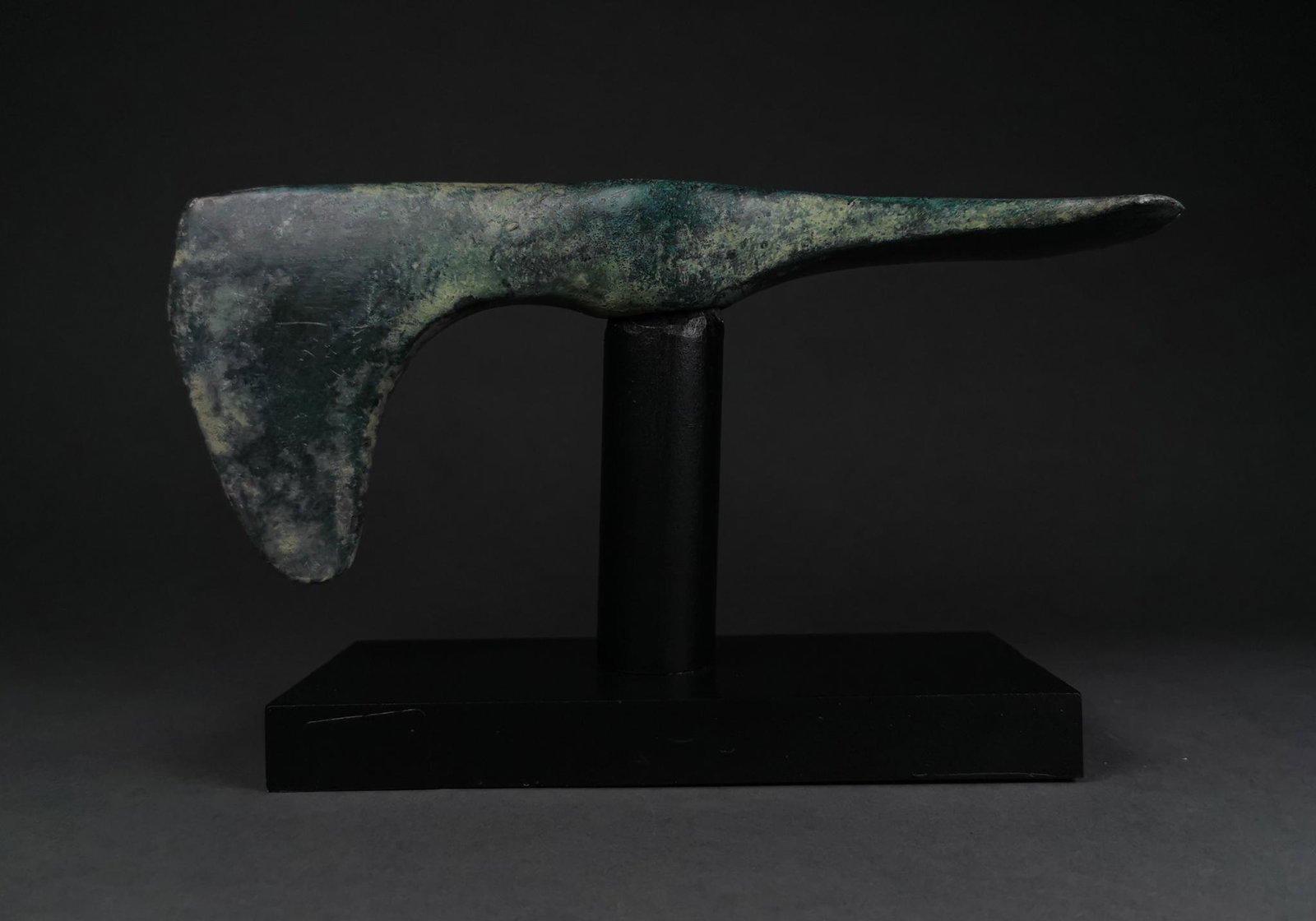 BRONZE AGE BATTLE AXE ON STAND - SUPERB PATINA: C. 2000-1000 BC, Bronze Age. Bronze double-headed axe with elongated, vertical blade to the front and flattened, horizontal blade to the rear. Bronze weaponry production flourished in Europe from the 