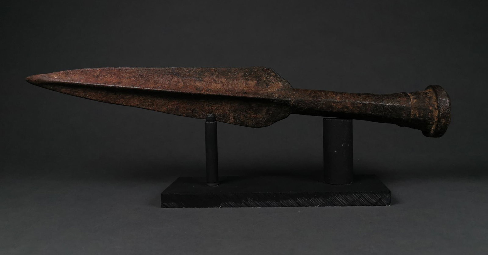 GIANT ROMAN IRON SOCKETED SPEARHEAD: C. 100 – 200 AD. Roman. A socketed iron spearhead comprising a large leaf-shaped, lentoid-section blade with raised midrib. Spearheads of this type were a key part of Roman military equipment and we