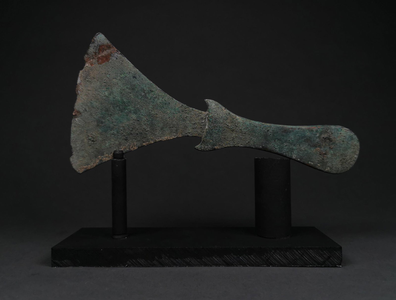 RARE BRONZE AGE FLAT AXE HEAD ON STAND: 1200-800 BC, Bronze Age Luristan..Rare bronze axe with flat, broad blade, which tapers to a cuvillinear tang featuring horn-shaped guard. Bronze weaponry production flourished in western Asia, the Aeg