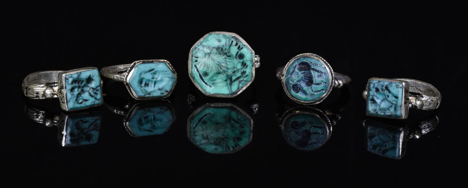 COLLECTION OF TRIBAL RINGS (5): Ca.1700-1950 AD. Yemeni Tribal. Lot of five white metal Yemeni Tribal intaglio rings with turquoise coloured stone settings. Yemeni tribal rings were made by Jewish silversmiths between the 18th and t