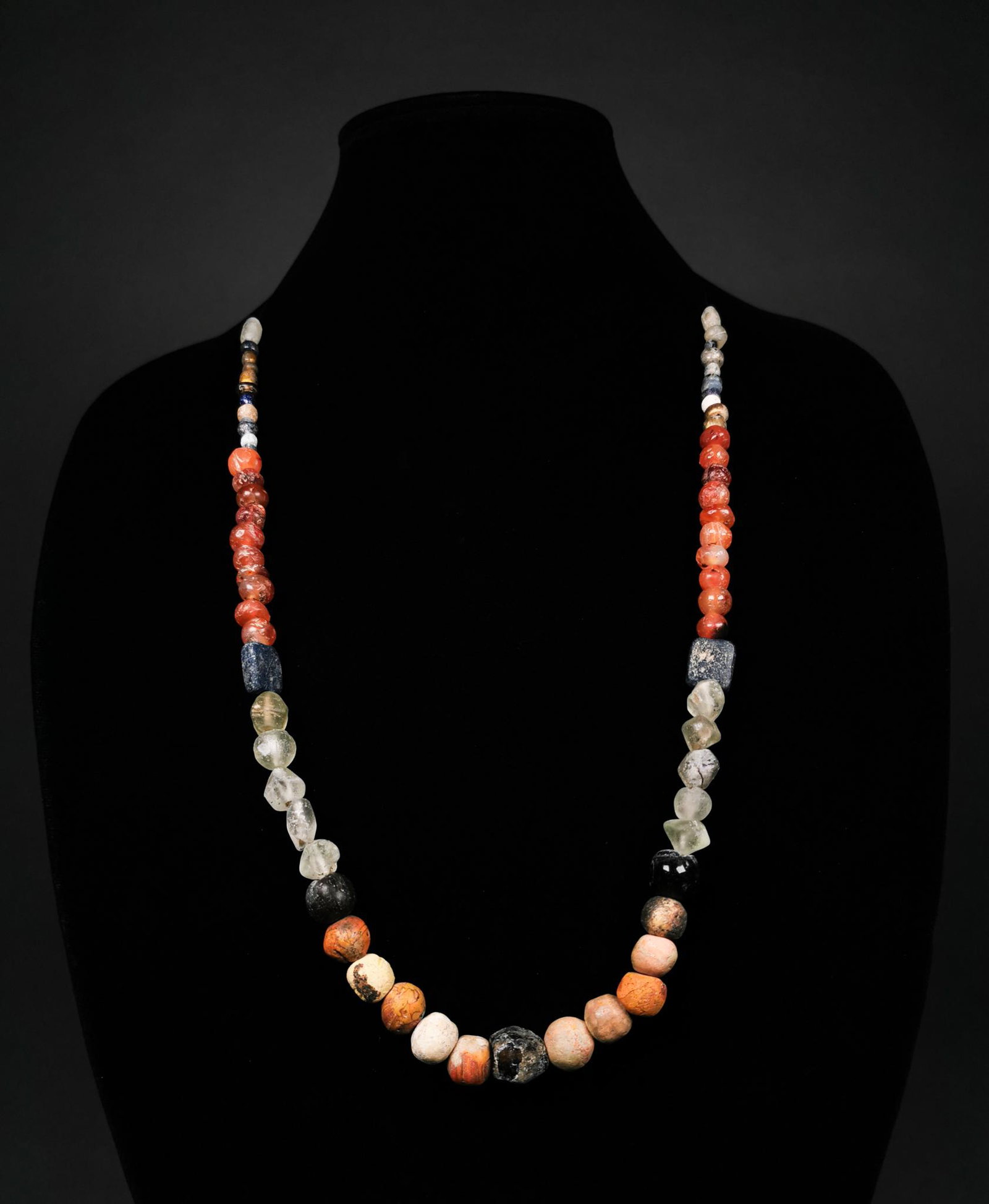 SUPERB ROMAN BEADED NECKLACE: Ca.1-300 AD, Roman. A superb restrung necklace comprising multiple glass and semi-precious stone beads (including a large number of Carnelian examples) in various shapes (e.g. spherical, rectangular a