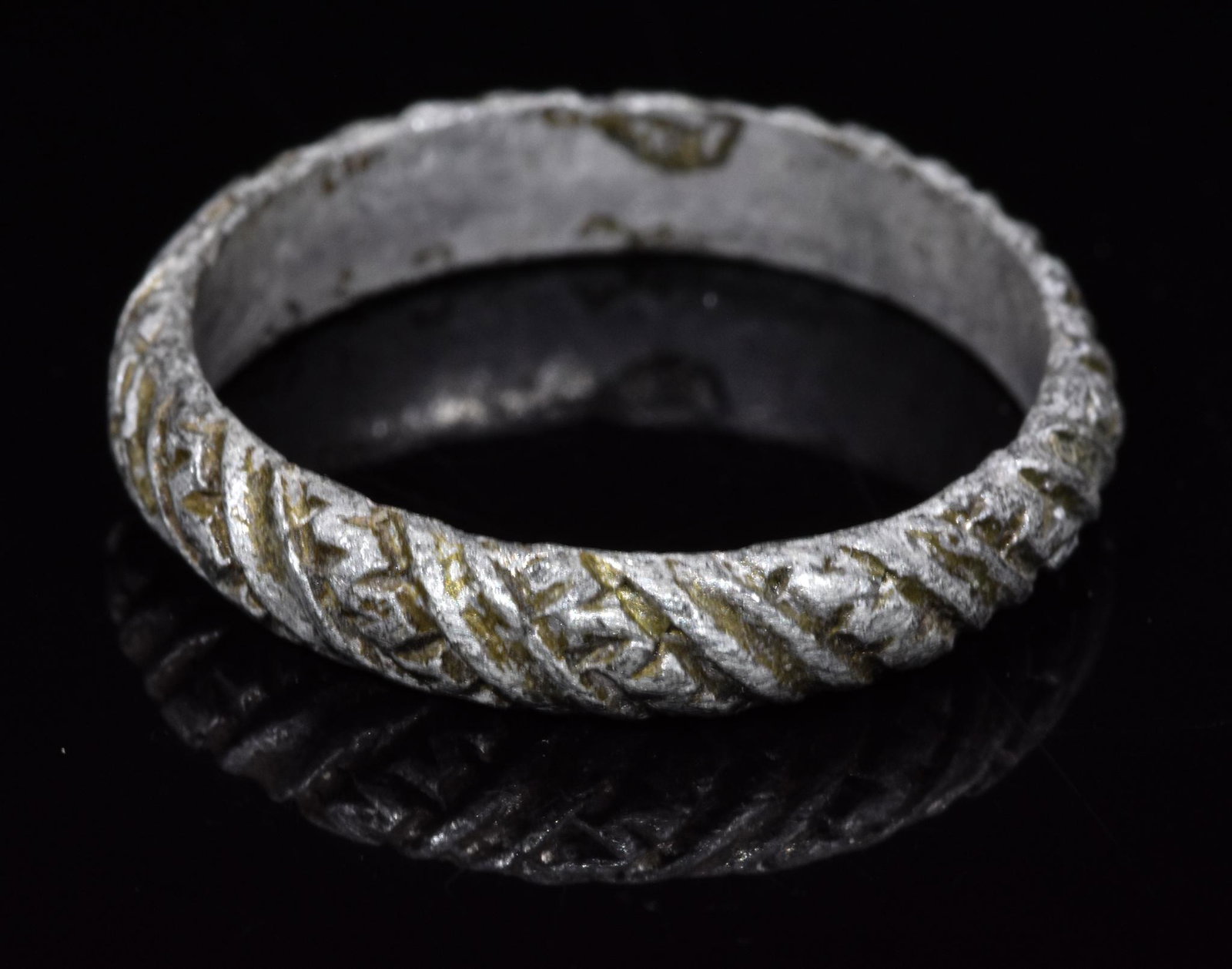 VIKING BRONZE DECORATED RING / BAND: 700-1100 AD, Viking Age. Bronze ring formed from a single band with a round hoop bearing incised decoration comprised of alternating diagonal plain and meandering bands. This simple yet elegant orname