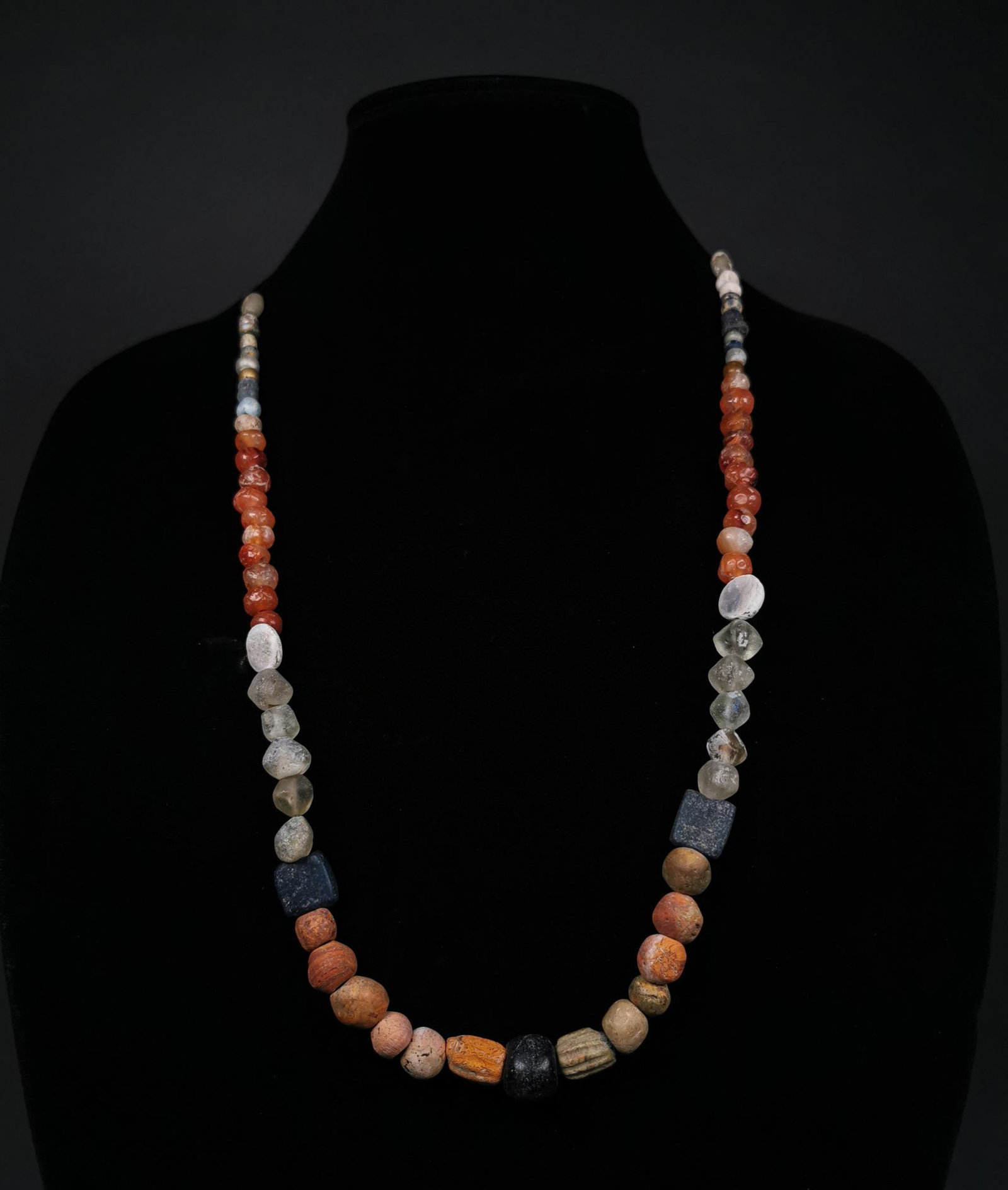 SUPERB ROMAN BEADED NECKLACE: Ca.1-300 AD, Roman. A superb restrung necklace comprising multiple glass and semi-precious stone beads (including a large number of Carnelian examples) in various shapes (e.g. spherical, rectangular a