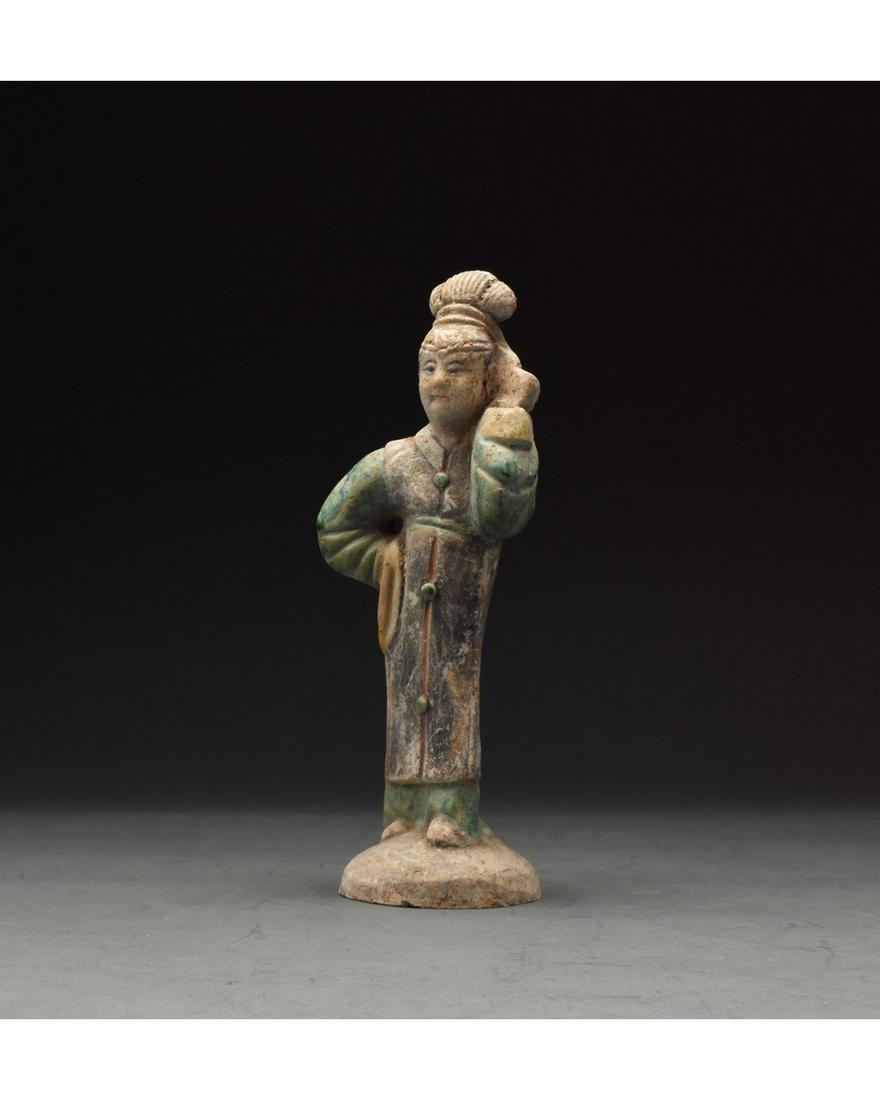 CHINESE MING DYNASTY GLAZED LADY FIGURE: Ca. 1368-1644 AD. Chinese Ming Dynasty Attendant Figure. An elaborately crafted female attendant figure dressed in a bright green dress with yellow cuffs, and a deep blue over-dress, which is trimmed 