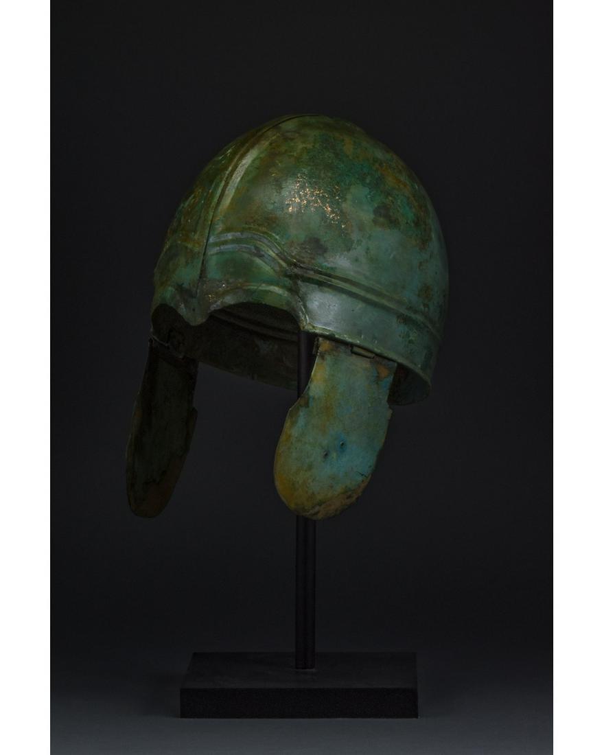 GREEK HOPLITE CHALCIDIAN TYPE HELMET - XRF tested: Ca. 400 BC. Very Rare Greek Chalcidian type Helmet with cheek-guards; embossed with geometric pattern and arched eyebrows; Similar helmets were worn by the Greek Hoplites during the time of Alexander 