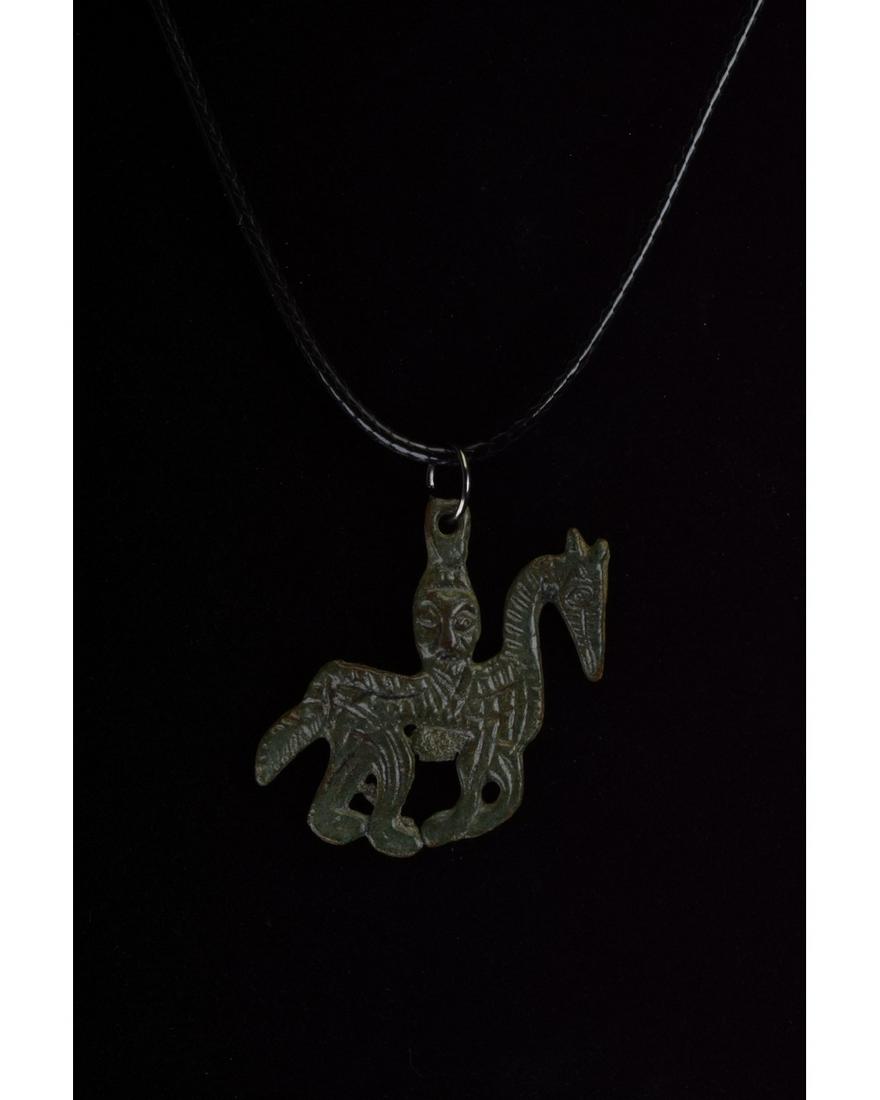 RARE VIKING ODIN ON HORSE AMULET: 700-1100 AD, Viking Age. Rare bronze amulet depicting a highly stylised rider, Odin, on horseback; a suspension loop protrudes from Odin’s head. Odin, who can be identified on the basis of his beard