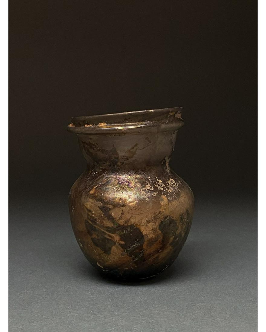 LATE ROMAN GLASS JAR: Ca. 1-300 AD Roman. A beautiful brown jar comprising a globular body, a short flaring neck with double outurned rims, and concave base. Glass was a major manufacturing industry in the Roman Empire, es