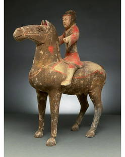 CHINA, HAN DYNASTY POTTERY FIGURE OF HORSE AND RIDER -: Ca. 202 BC-220 AD. Chinese Han Dynasty. Terracotta Horse with Rider. An elegant hollow-moulded terracotta horse. This bay horse is modelled in a standing pose with its neck elegantly arched and its