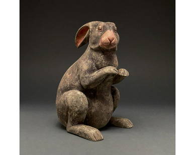 CHINA, HAN DYNASTY POTTERY RABBIT- TL TESTED: Ca. 206 BC - 220 AD. Attractive Han dynasty terracotta rabbit. A hollow-formed terracotta rabbit figurine; with black pelt and coral-pink pigmentation on the nose. The rabbit is depicted sitting on