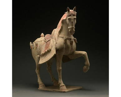 CHINA, HUGE TANG DYNASTY POTTERY PRANCING HORSE - TL: Ca. 618 - 907 AD. Chinese Tang Dynasty. An elegant hollow-moulded terracotta horse. This horse is modelled in a standing pose, with one foreleg lifted. The animalâ€™s neck is beautifully arched