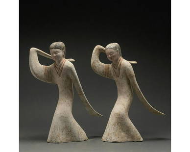 RARE PAIR OF CHINESE HAN DYNASTY DANCING LADIES - TL: C. 202 BC to 220 AD. Han Dynasty. A pair of delicate Han Dynasty dancers with long sleeves. Both dancers are wearing a long flowing gowns with overlength sleeves which hide their hands. Both are in