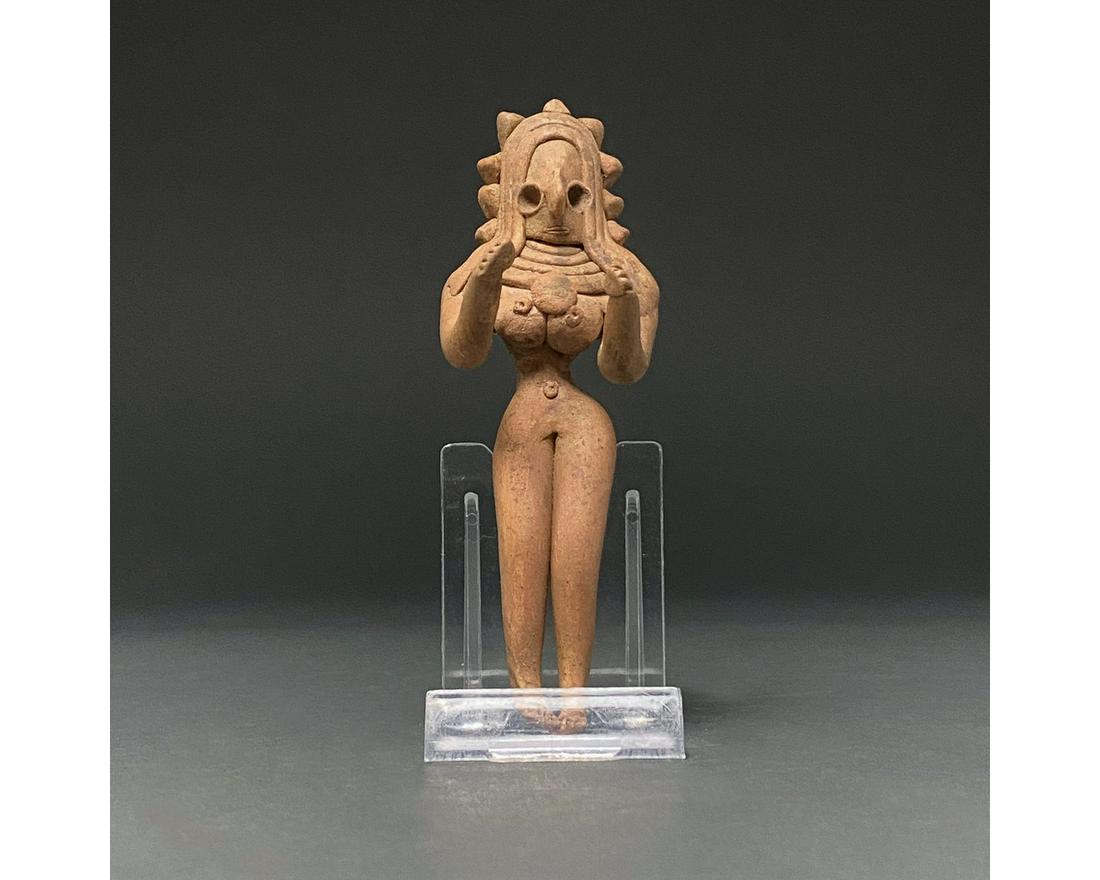 INDUS VALLEY POTTERY FERTILITY IDOL FIGURE: C. 3rd millennium BC Indus Valley.. A lovely buff-coloured handmade fertility idol of characteristically abstract form with delineated legs, curved arms reaching forward, voluptuous breasts situated b