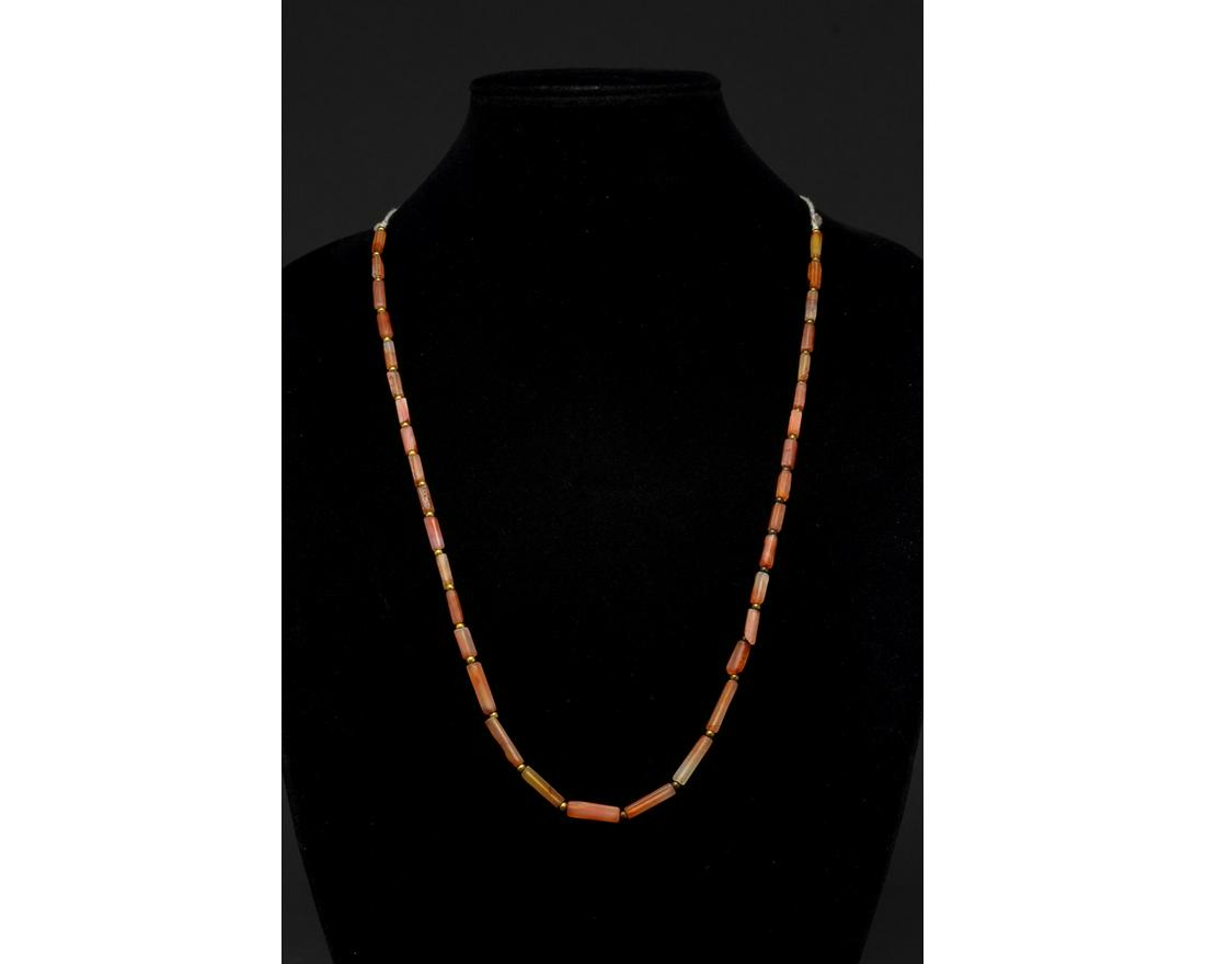 ROMAN CARNELIAN STONE NECKLACE - WEARABLE: Ca. 100-300 AD. Roman. A restrung necklace of beautiful tubular semi-precious carnelian beads spacced by small, round metallic beads. This necklace is just as beautiful a statement piece today as it w