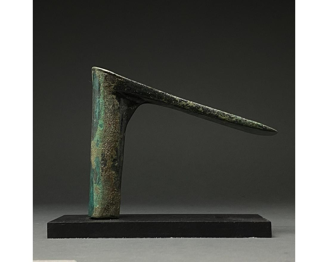 BRONZE AGE BATTLE AXE: C. 2000-700 BC. Luristan culture. A bronze battle axe with a horizontal, wedge-shaped blade, and cylindrical haft. Bronze weaponry production flourished from the 2nd millennium BC to about 700 BC when