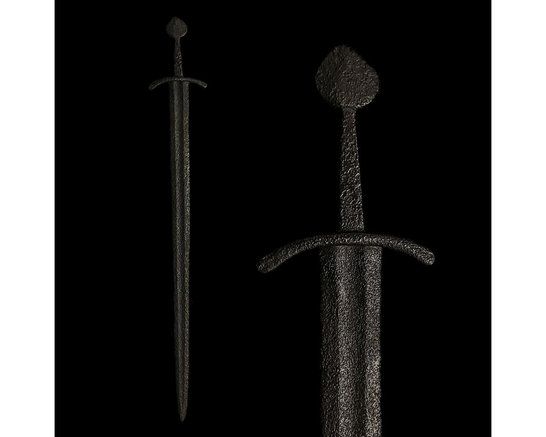 VIKING IRON SWORD WITH HANDLE: 900-1100 AD. Viking age. An iron sword with a long, doubled-edged blade, with a deep fuller or "blood-groobe" culminating in a point, a simple lunate guard and an integral handle with a spade-shaped p