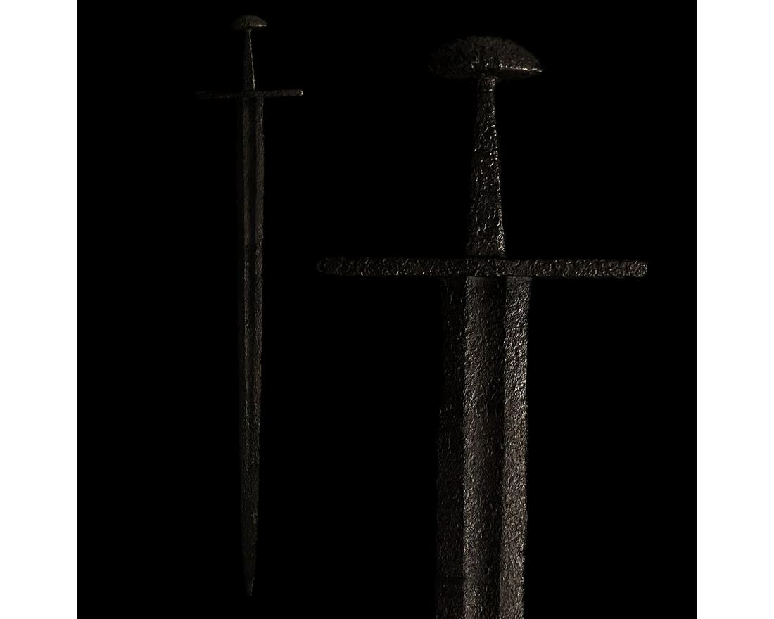 VIKING IRON SWORD WITH HANDLE: 700-1000 AD. Viking age. An iron sword with a long, doubled-edged blade, culminating in a point with a wide, rectangular guard and hemi-spherical pommel, corresponding broadly to Petersenâ€™s Typ