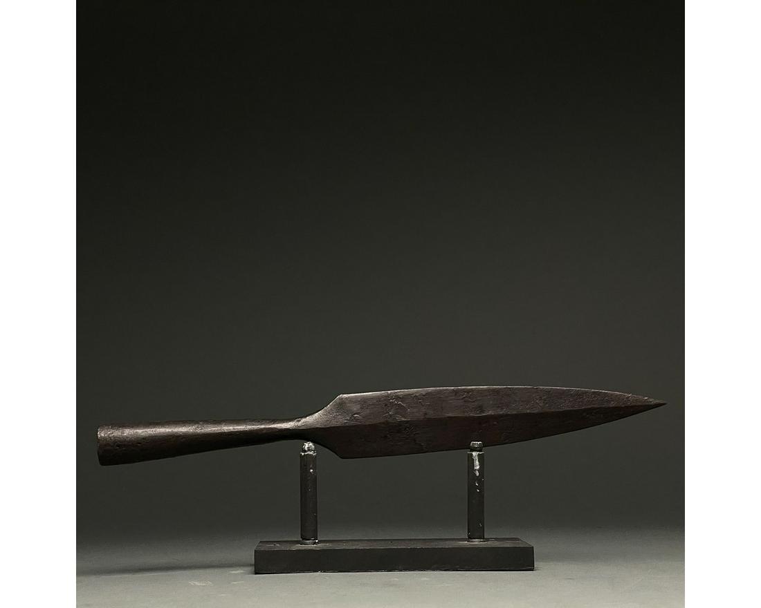 LARGE ROMAN IRON SOCKETED SPEAR HEAD: C. 300-500 AD Roman. An iron spearhead comprising a slender tapering leaf-shaped blade with a raised midrib and a long socket for increased control. Weapons of this type were used in the Late Roman pe