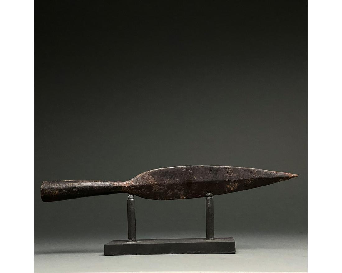 LARGE ROMAN IRON SOCKETED SPEAR HEAD: C. 300-500 AD Roman. An iron spearhead comprising a slender tapering leaf-shaped blade with a raised midrib and a long socket for increased control. Weapons of this type were used in the Late Roman pe