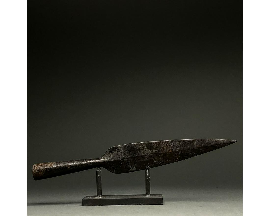 LARGE ROMAN IRON SOCKETED SPEAR HEAD: C. 300-500 AD Roman. An iron spearhead comprising a slender tapering leaf-shaped blade with a raised midrib and a long socket for increased control. Weapons of this type were used in the Late Roman pe