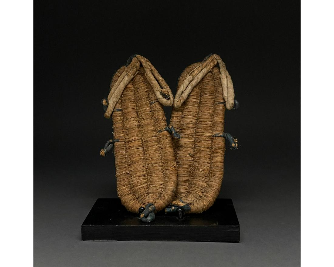 ANCIENT EGYPTIAN SANDALS: c.1390-1352 BC, Ancient Egyptian, 18th Dynasty. An exceptionally well-preserved pair of ancient reed and palm leaf sandals with straps and blue dyed tassels. The exceptionally dry conditions of the Eg