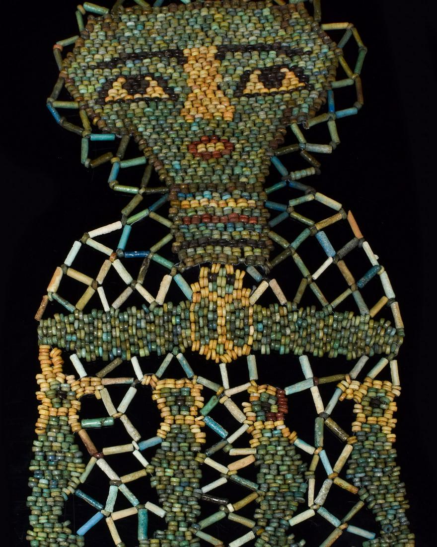 ANCIENT EGYPTIAN FAIENCE BEADED MUMMY SHROUD WITH: Ca. 332 B.C. Late Period. Egyptian. An ancient Egyptian mummy shroud of beadwork from the chest of a mummified person, consisting of a net of black barrel and green tubular beads with yellow ring bead