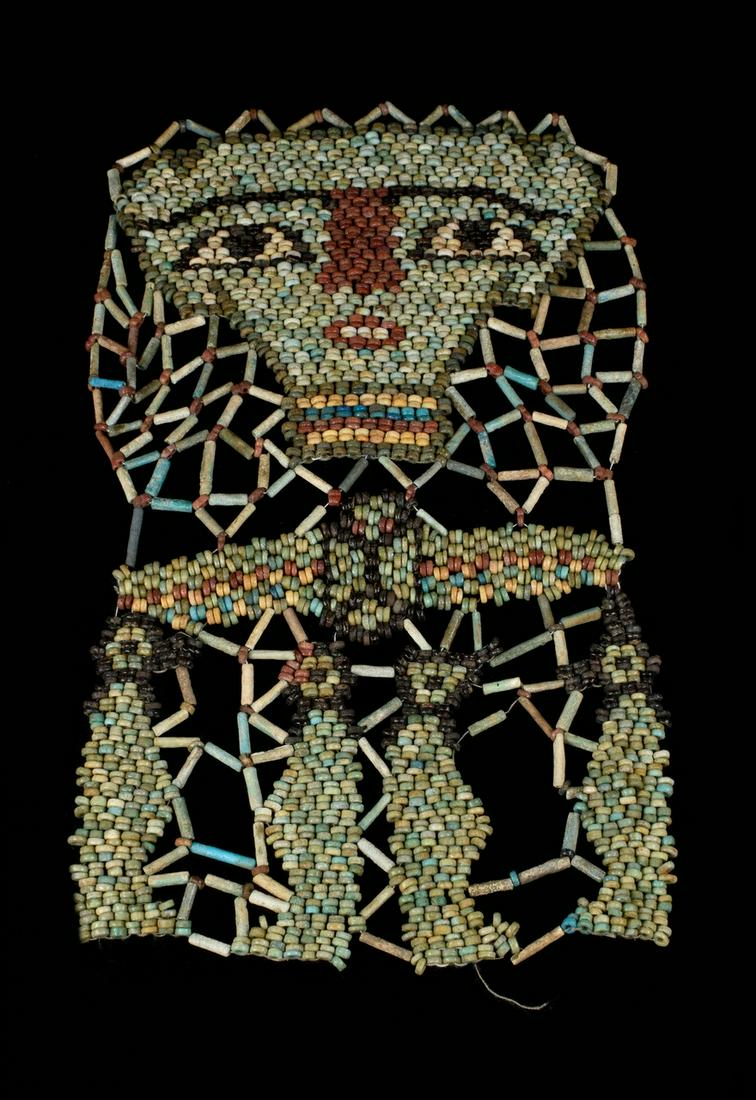 AN EGYPTIAN FAIENCE MUMMY SHROUD WITH FOUR SONS OF: Late Period, Circa 664 -332 BC An ancient Egyptian mummy shroud of beadwork from the chest of a mummified person, consisting of a net of dark green barrel and light green tubular beads with green ring