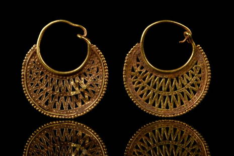 BYZANTINE GOLD OPENWORK FILIGREE EARRINGS: Ca. 600-700 ADA stunning pair of gold earrings each comprising an inverted drop-shaped hoop ornamented with an applied wave.The medieval empire of Byzantium was justly famous for the elegance of its