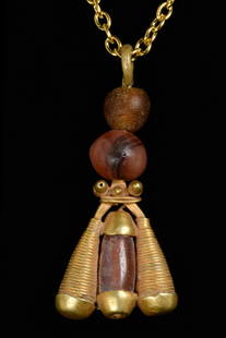 GREEK GOLD AND CARNELIAN FLY PENDANT: Ca. 100 BCHellenistic PeriodA gold pendant in the form of a fly, with the body formed of carnelian and two winged forged with gold. Above two carnelian beads conjoined with a suspension loop and gold