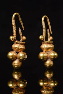 ROMAN GOLD EARRINGS WITH GRANULATION: Ca. 100-300 ADA substantial pair of Ancient Roman gold earrings featuring a large convex shaped bead which looks like a vessel, with a beautiful pendant decorated with fine granulation on its rim;