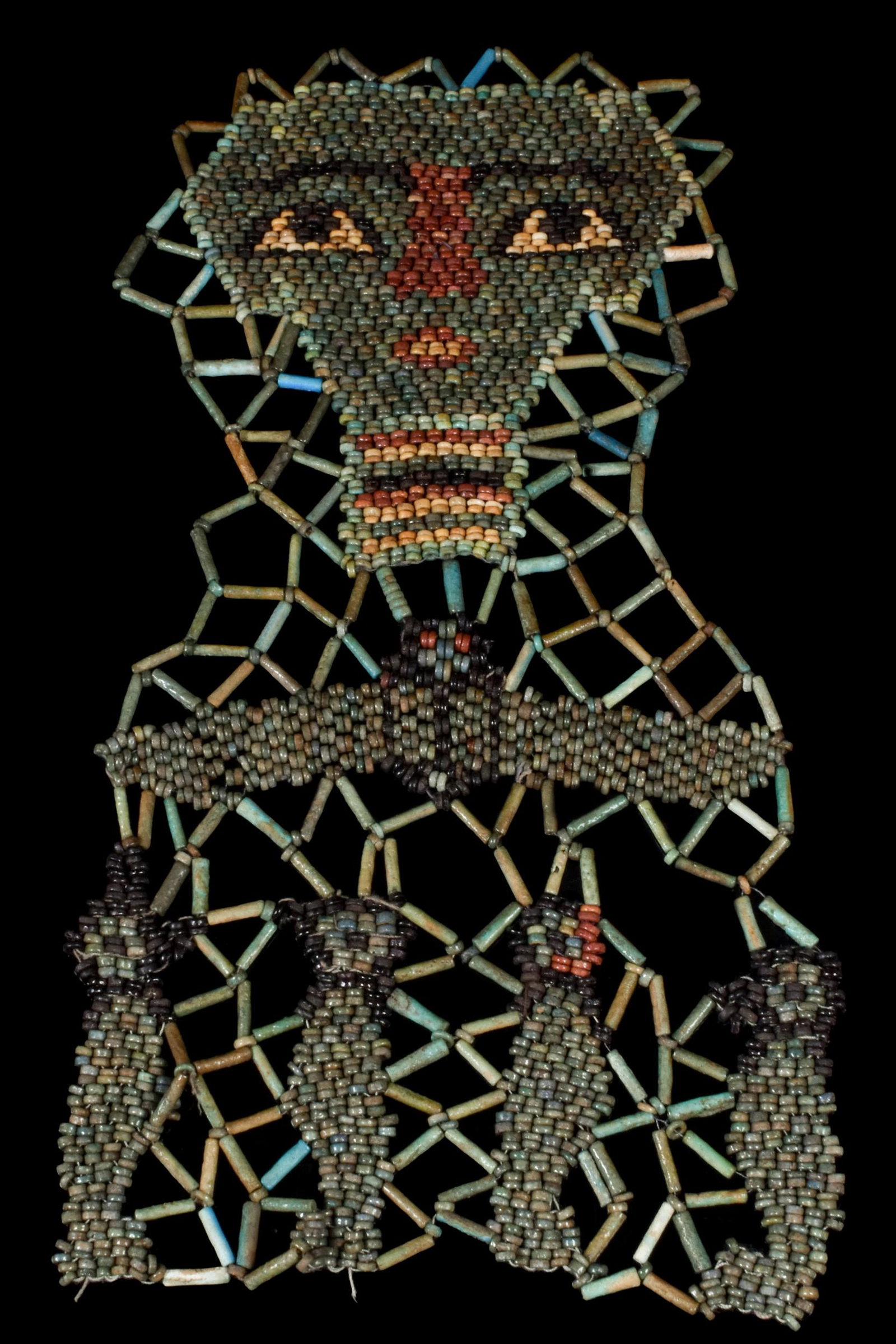 EGYPTIAN FAIENCE BEADED MUMMY SHROUD: Late Period, Ca. 664-332 BC An ancient Egyptian mummy shroud of beadwork from the chest of a mummified person, consisting of a net of green ring and tubular beads to forming the face, the skin made of