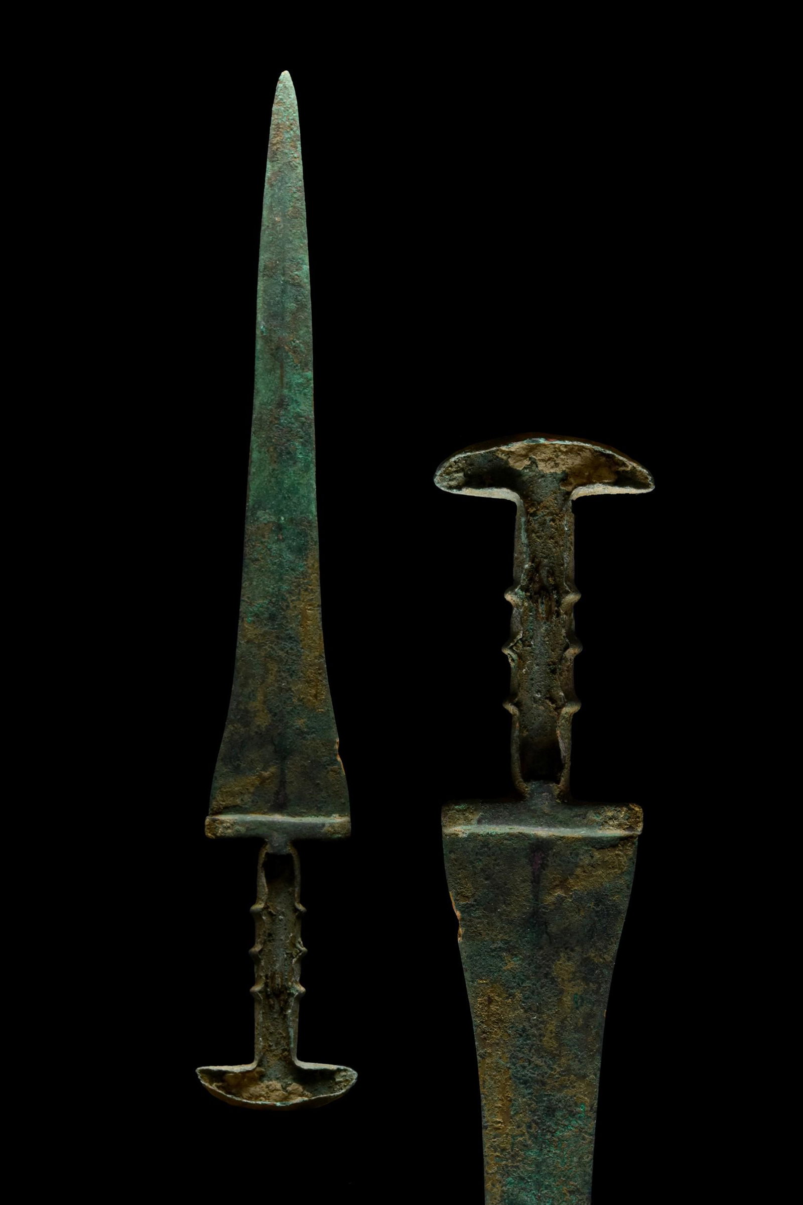 WESTERN ASIATIC BRONZE DAGGER: Ca. 1100-540 BC A finely cast Elamite bronze dagger, comprising a triangular-shaped, double-edged blade with raised mid-rib and a flanged, hollowed hilt. For a comparison see: The British Museum 13608