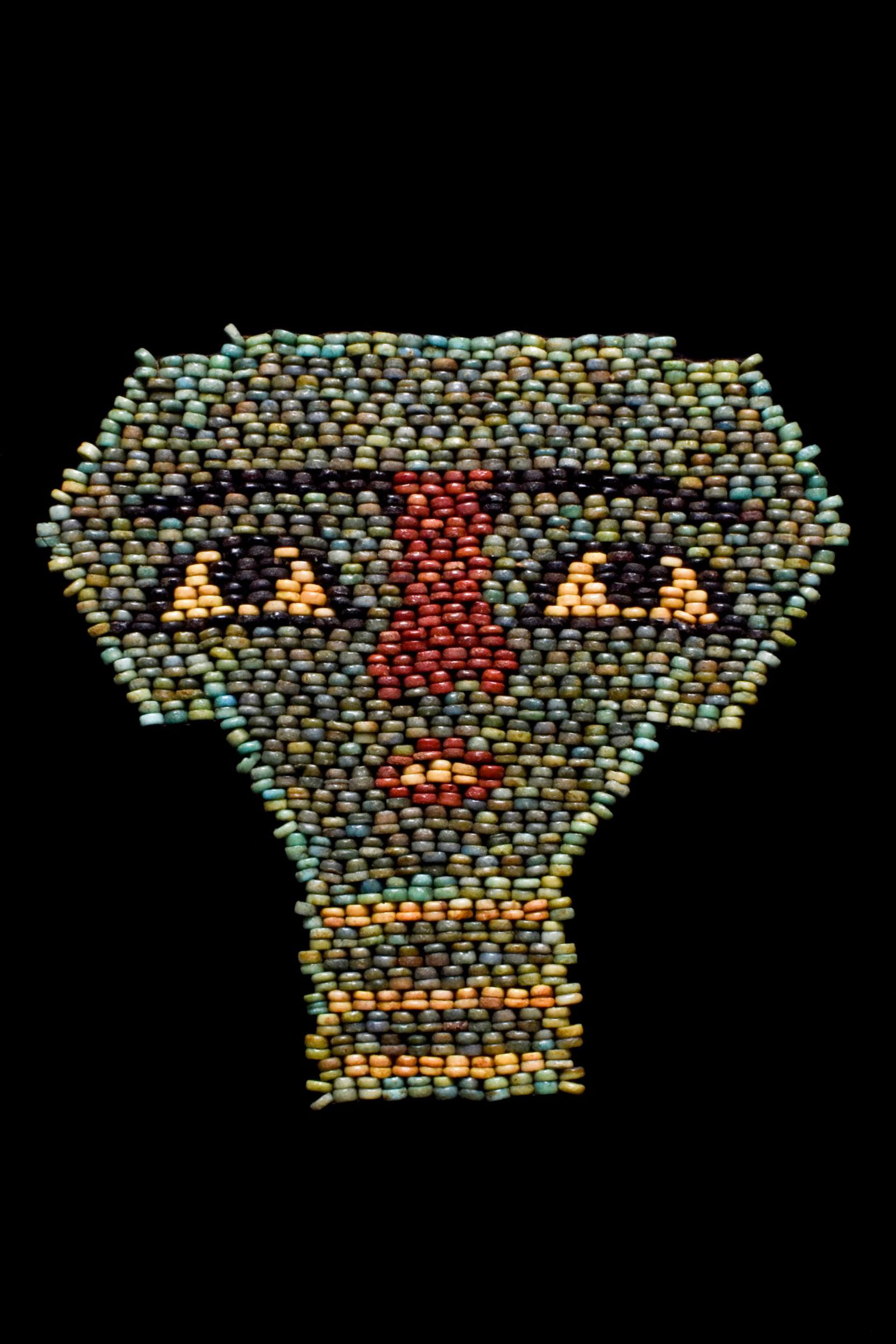 ANCIENT EGYPTIAN FAIENCE MUMMY MASK: Late Period, Ca. 664-332 BC A mask, formed of an array of colourful beads, in the form of a human face with a neutral expression. The face consists of large, trapezoid eyes, long, thin eyebrows, a bro