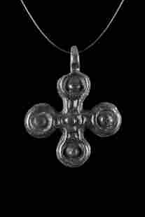 BYZANTINE BRONZE CROSS PENDANT: Ca. 1000-1300 AD. A cruciform pendant crafted from bronze features four circular terminals with a raised dot at the center of each. A suspension loop at the top provides a perfect finishing touch. The