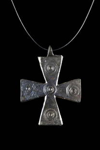 BYZANTINE BRONZE CROSS PENDANT WITH FIVE WOUNDS OF CHRIST: Ca. 600-800 AD. A bronze cross pendant meticulously crafted from bronze, with flaring terminals that give the piece a unique and dynamic look. At the junction and at each arm, there is a concentric ci