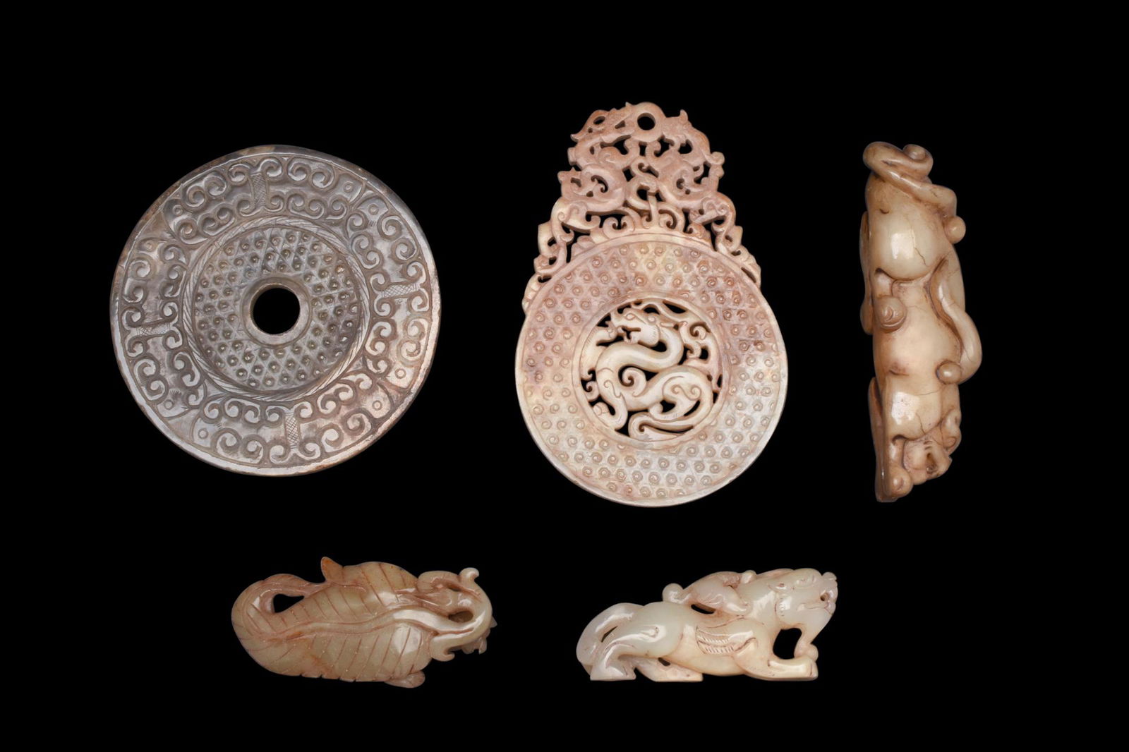 HARDSTONE / JADE CARVINGS: A lovely collection of hardstone bi discs (2) and zoomorphic beast carvings (3). Bi disc are some of the most fascinating decorative objects in Chinese art. These flat, circular disks were commonly us