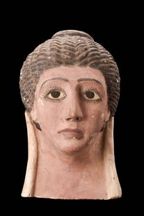 EGYPTIAN POLYCHROME MASK WITH GLASS EYES: Roman Period, ca. 30 BC - 323 AD. A moulded ceramic funerary mask of a youthful female with braided hair drawn to the top of the head, painted detailing to the eyes, eyebrows, hair, lips, earrings