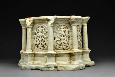 BYZANTINE MARBLE RELIQUARY WITH PILLARS: Ca. 300-900 AD. A drum-shaped marble chest in the form of a tholos surrounded by eight columns with simple capitals, arcades between the pillars with elegant openwork foliate tracery; each tiered