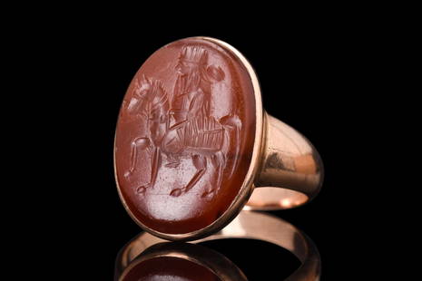 SASANIAN HORSERIDER INTAGLIO IN GOLD RING: Ca. 500 - 600 AD. A rare gold ring featuring an exquisite intaglio of a Sasanian horserider seated with ease atop his mount, his face finely detailed with an abundant beard and hair, topped with a