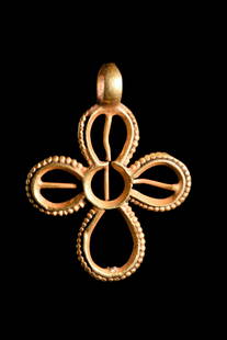 BYZANTINE GOLD CROSS PENDANT: Ca. 600-800 AD. A gold cruciform pendant of an openwork design, featuring four arms with beaded edges and rounded finials. The cross has a long and rich history. It has been used as a sacred symbol of