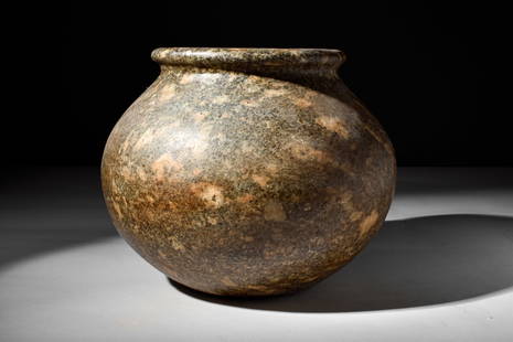 EGYPTIAN GRANITE VESSEL: Ca. 3000-1793 BC.A granite vessel with a bulbous body that elegantly emerges from a circular base. The body terminates in a thick, rounded rim. Size: 200mm x 240mm; Weight: 6.7kg Provenance: Property