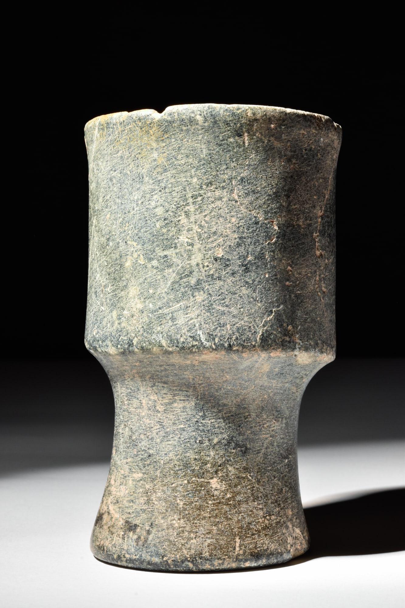 MESOPOTAMIAN STONE CHALICE CUP: Ca. 3rd Millenium BC.A chalice cup carved from one piece of stone, with a tapered stem foot and a cup part with a slightly corsetted wall. Size: 110mm x 70mm; Weight: 460g Provenance: Private UK colle