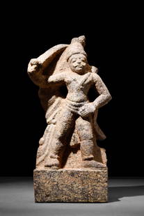 GANDHARAN STYLE STONE STATUE OF A WARRIOR: Possibly Gandharan, Ca. AD 300 or later.A dynamic stone statue featuring a male warrior who is elevated on a rectangular plinth. The statue depicts a standing figure who leans to the left, left arm re