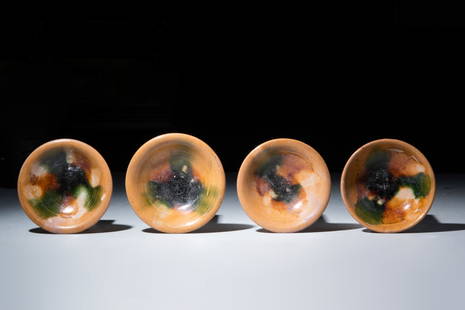 FOUR CHINESE SANCAI GLAZED BOWLS: Tang Dynasty, Ca. AD 618–907.A group of four terracotta sancai glazed bowls. Each bowl has a circular disc foot and slightly rounded, unglazed walls. The insides of the bowls are splashed with the