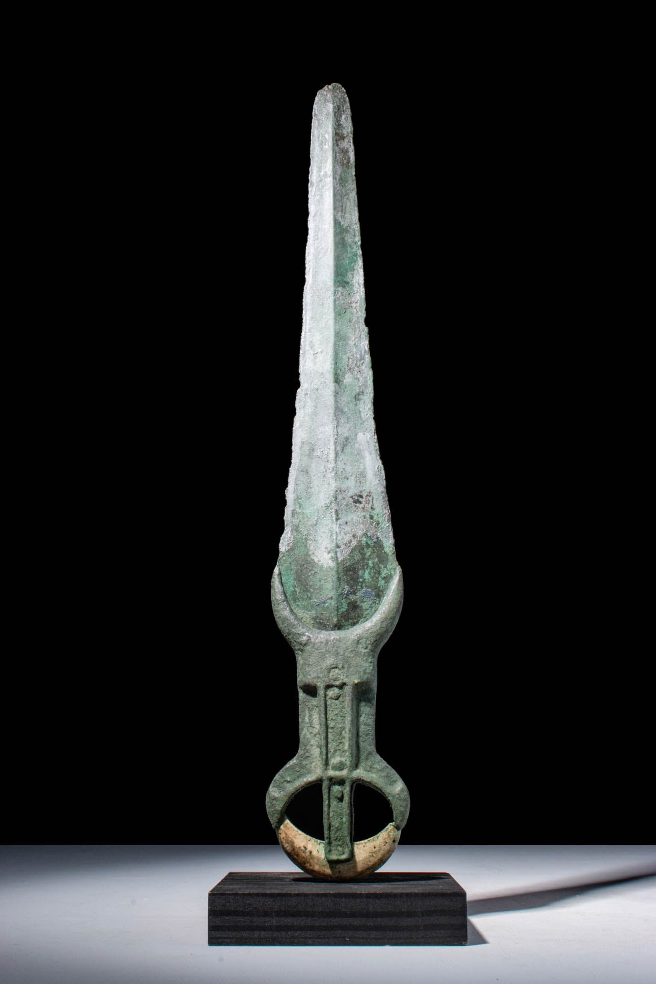 ANCIENT EGYPTIAN MIDDLE KINGDOM BRONZE OR COPPER ALLOY DAGGER: Middle Kingdom, 11th Dynasty, Ca. 2055 - 1790 BC. An Egyptian Middle Kingdom bronze double-edged dagger, tapering blade bears a central ridge. The handle is cast of two parts which are riveted to hold