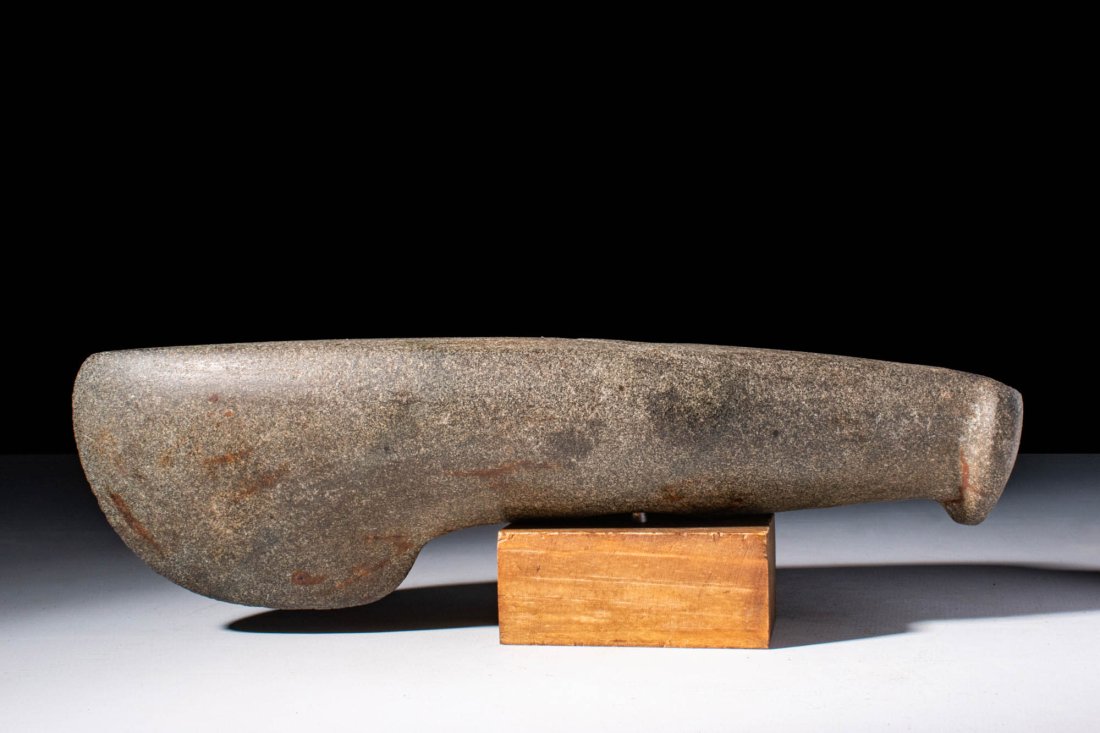 A VERY RARE FATJANOVO CULTURE STONE BATTLE AXE: Ca. 3000 - 2000 BC. A fatjanovo granite stone battle axe or hammer with a large and heavy head. The centre of the weapon features a drilled vertical hole. Size: 250mm x 75mm; Weight: 1.56kg Provenance