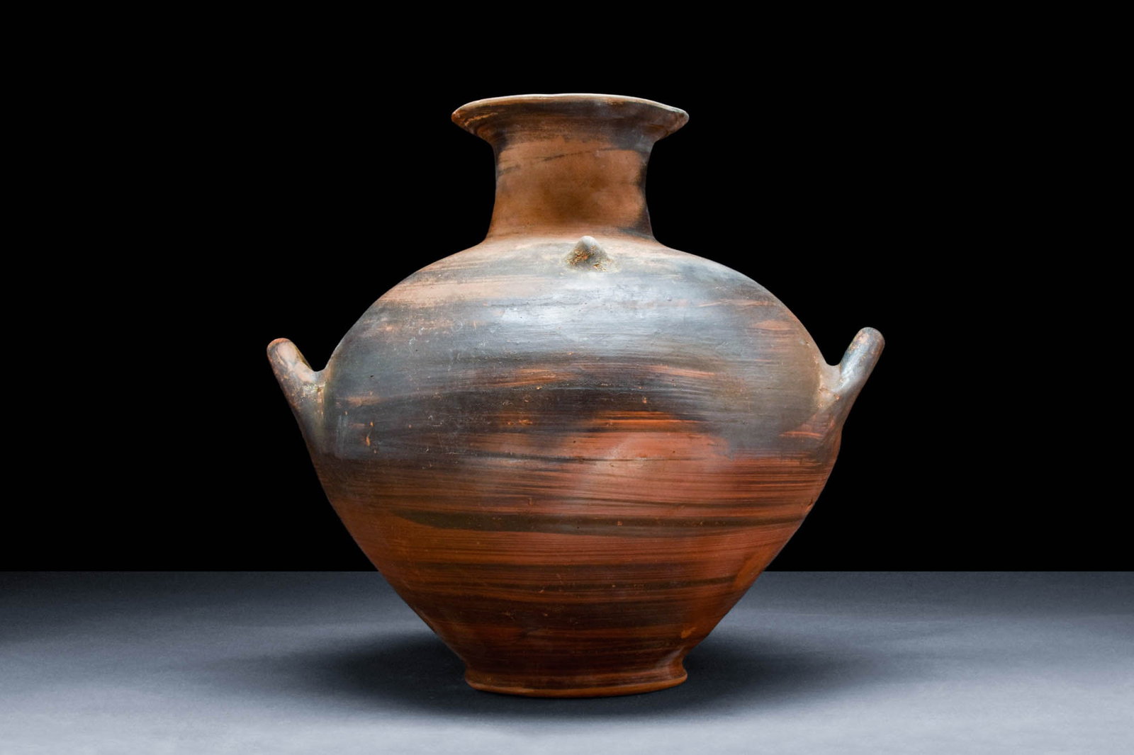 SUPERB VILLANOVAN POTTERY AMPHORA: Ca. 800 - 600 BCA large Villanovan terracotta globular jar with a broad-shouldered body tapering to the base. The cylindrical neck features a wide flange. Two diagonally oriented handles protrude from