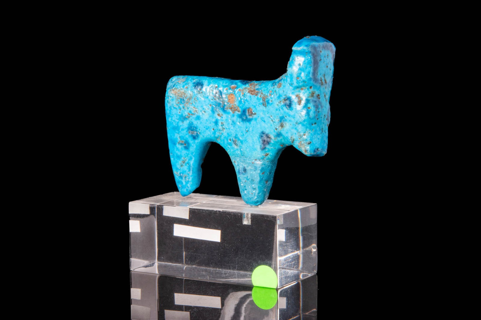 EGYPTIAN NEW KINGDOM BLUE FAIENCE FIGURINE OF BULL: New Kingdom, Ca. 1550 - 1069 BC.An elegant blue faience amulet depicting the goddess Hathor. She is depicted in bull form, with the solar symbol between her long horns. Enveloped in a brilliant, azure