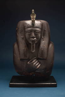EGYPTIAN WOODEN BUST OF PHARAOH WITH BRONZE COBRA: New Kingdom, Ca. 1550 - 1069 BC. A wooden bust of a pharaoh. The face is solemn, with almond-shaped eyes, a defined nose, and full lips that convey a sense of authority. The head is adorned with a
