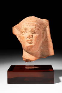 EGYPTIAN TERRACOTTA HEAD OF PHARAOH: Ptolemaic Period, Ca. 332 - 30 BC.A terracotta head of a Pharaoh from the Ptolemaic dynasty, characterised by elegant facial features and covered with a large Nemes headdress. For similar see: The